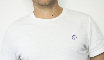 man wearing white crew-neck shirt and black denim jeans with hands in pocket